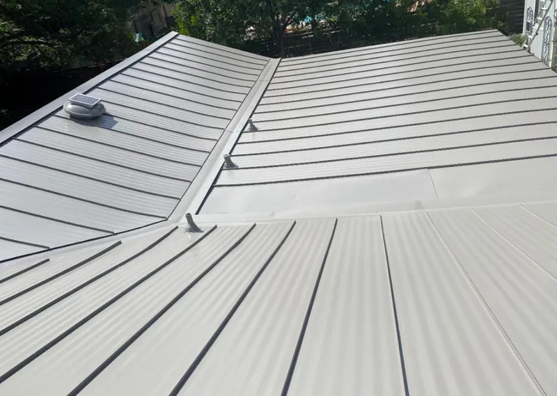 Solar attic fan installed on a metal roof for Roof Ventilation in Oak Hill